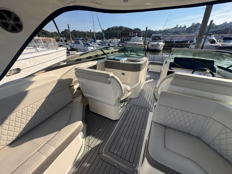 Slide: The Image of The image shows the cockpit of a 2020 Sea Ray SLX 310 Outboard with luxurious seating. - 14