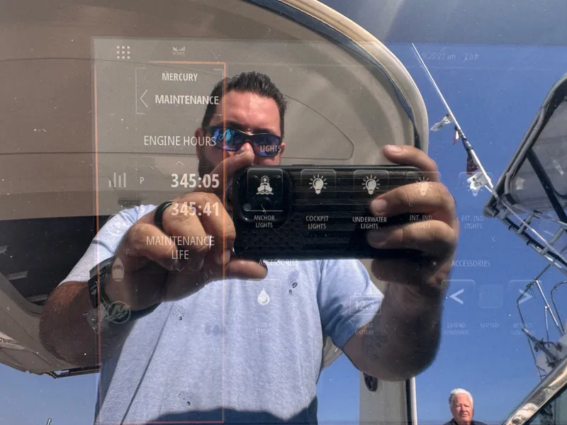 Slide: The Image of A man is reflected in a screen on a boat displaying maintenance information. - 17