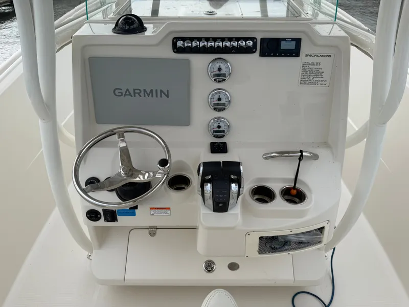 Slide: The Image of The image shows the helm of a 2014 Sailfish 290 CC with Garmin navigation and instruments. - 19