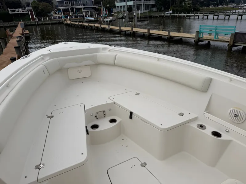 Slide: The Image of The image shows the cockpit of a 2014 Sailfish 290 CC with white seating and storage areas. - 11