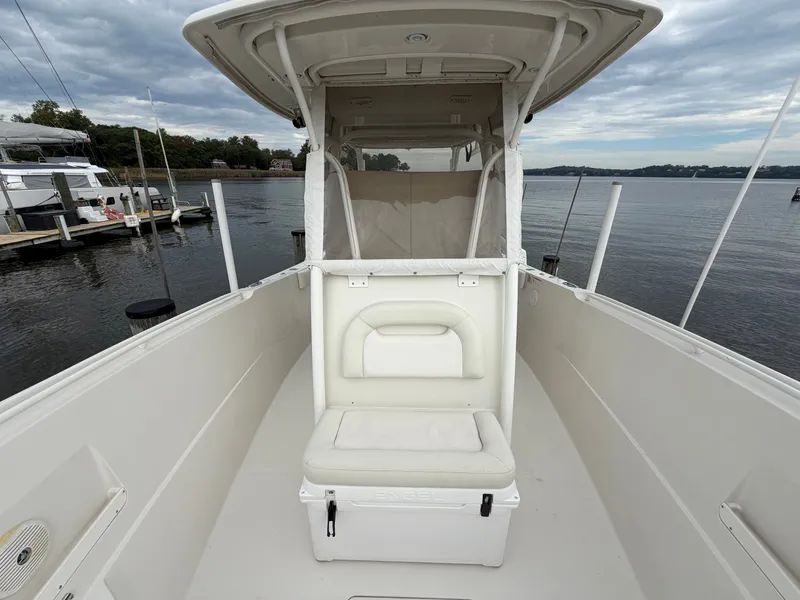Slide: The Image of The image shows the cockpit of a 2014 Sailfish 290 CC with a seat and cooler. - 16