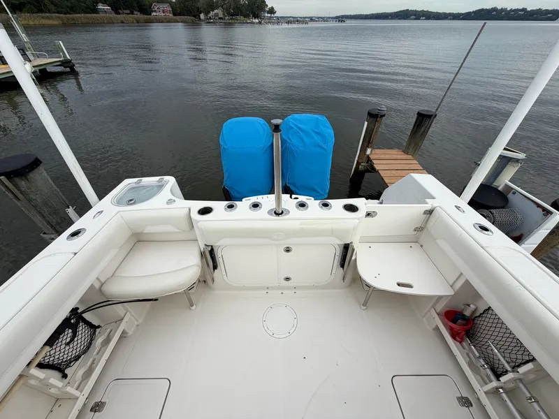 Slide: The Image of The image shows the cockpit of a 2014 Sailfish 290 CC with two covered outboard engines. - 18