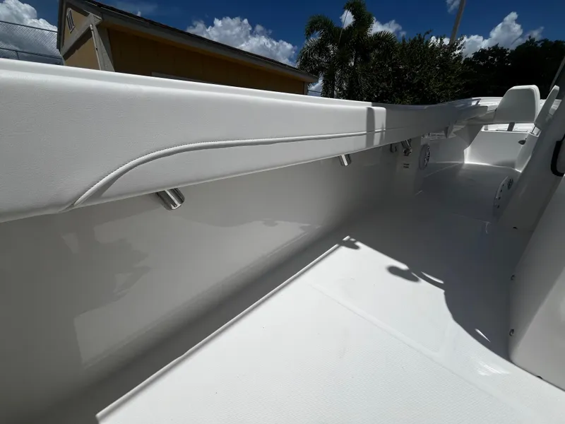 Slide: The Image of 2025 Regulator 23 boat interior with white deck and side rail. - 16