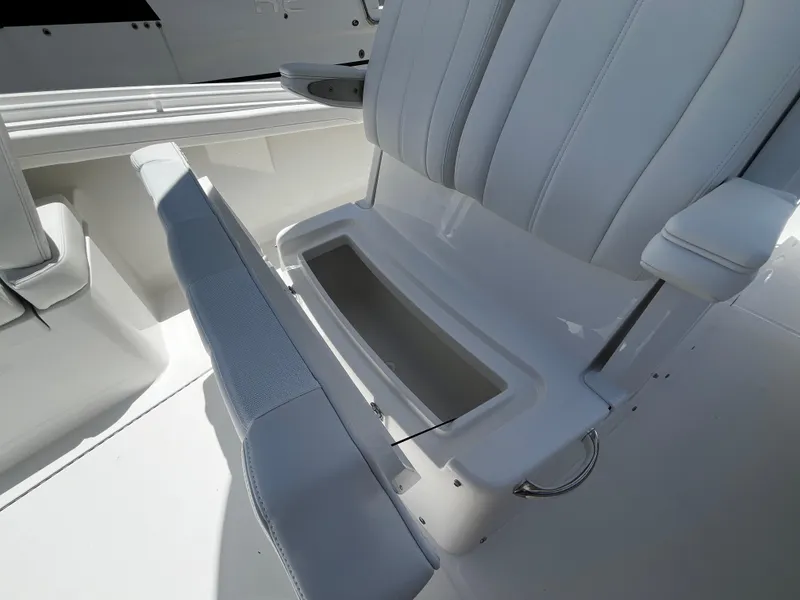 Slide: The Image of 2025 Regulator 23 boat with open storage compartment under seat. - 24