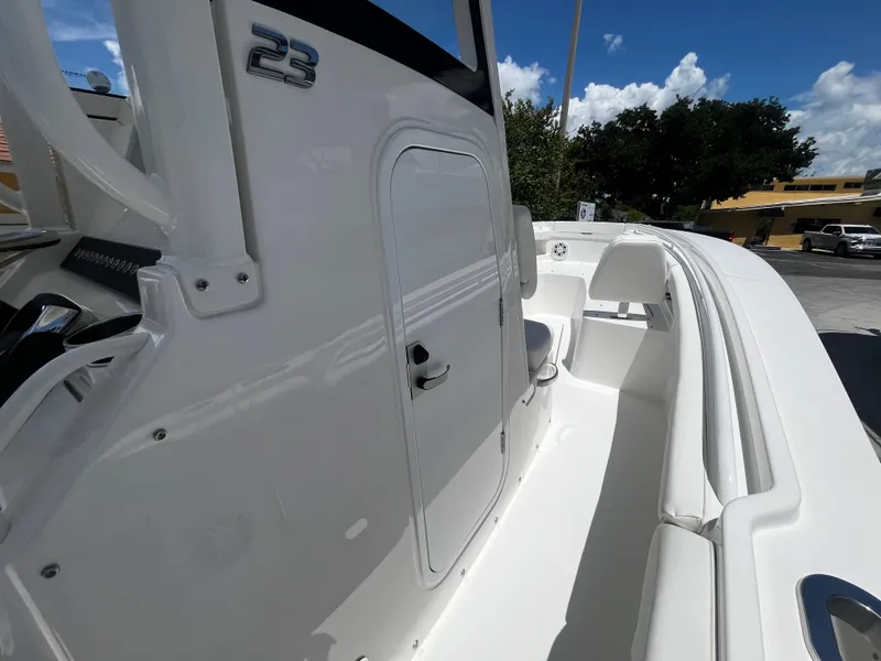 Slide: The Image of 2025 Regulator 23 boat deck with storage compartment and seating. - 17