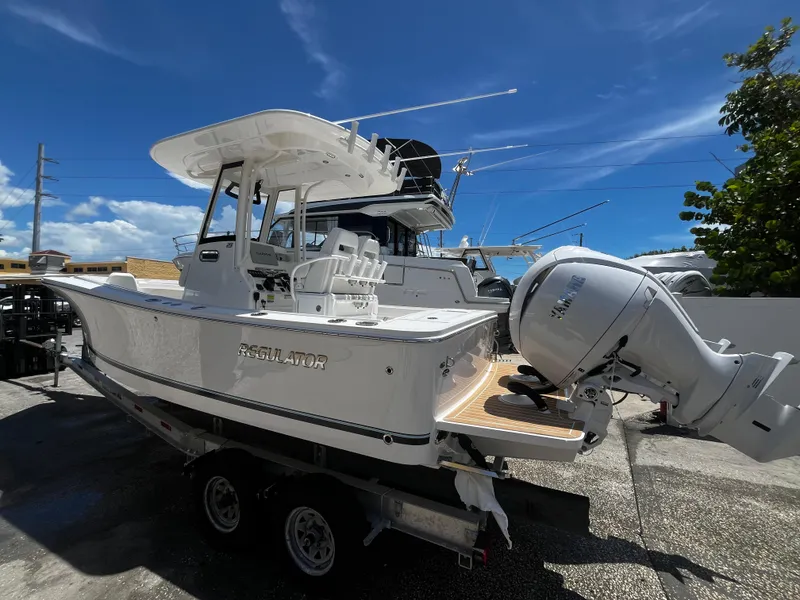 Slide: The Image of 2025 Regulator 23 boat on trailer with outboard motor. - 4