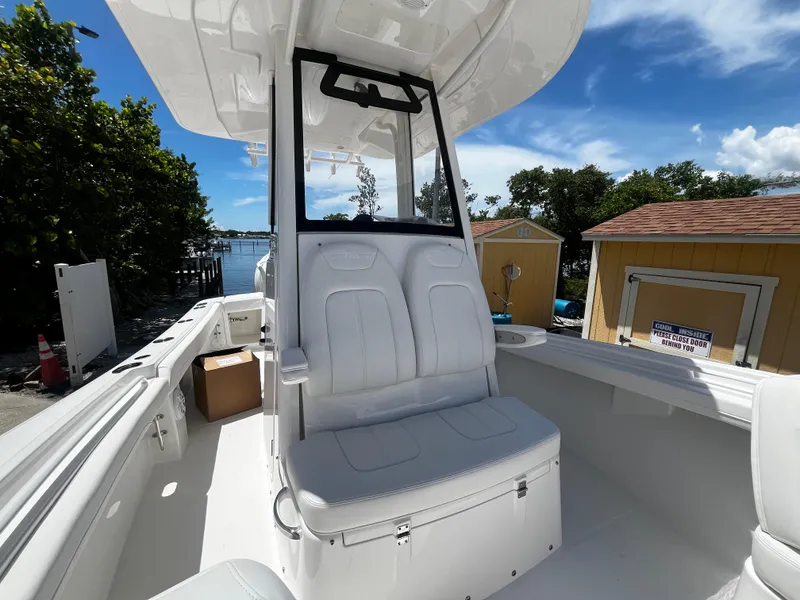 Slide: The Image of 2025 Regulator 23 boat interior with white seating and console. - 23