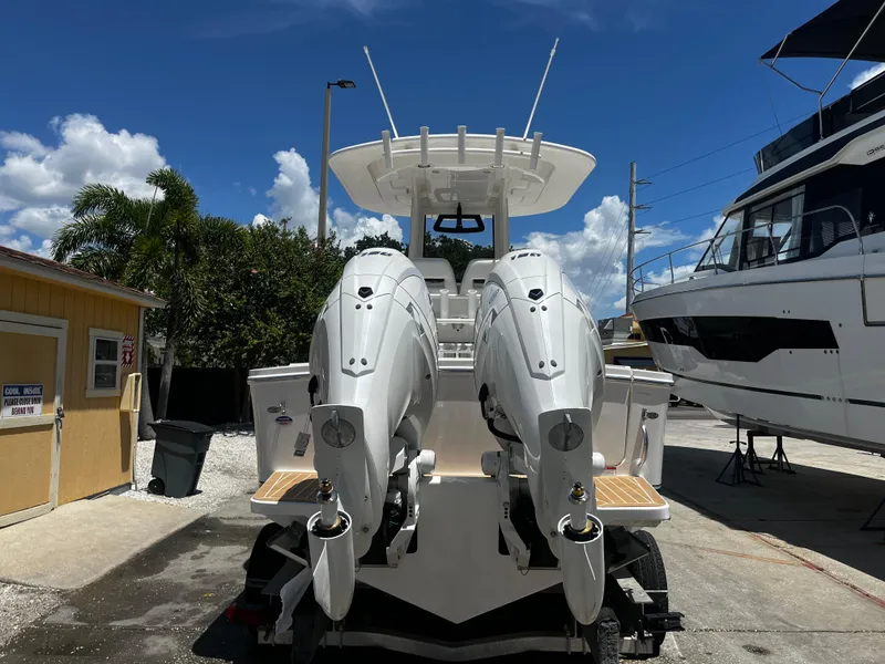 Slide: The Image of 2025 Regulator 23 boat with twin outboard engines in a marina. - 3