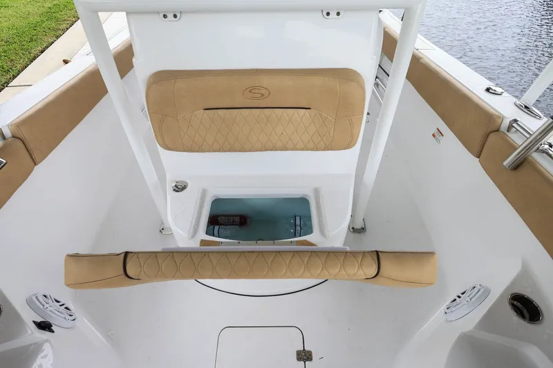 Slide: The Image of 2018 Sportsman Open 282 Center Console boat interior with cushioned seating and storage compartment. - 17