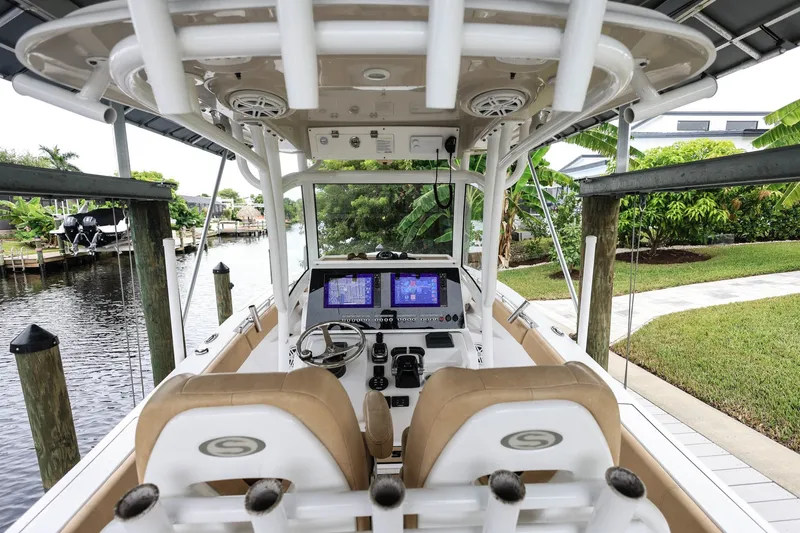 Slide: The Image of 2018 Sportsman Open 282 Center Console boat interior with dual screens and steering wheel. - 7