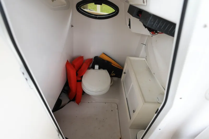 Slide: The Image of Interior of 2018 Sportsman Open 282 Center Console boat with life jackets and toilet. - 12