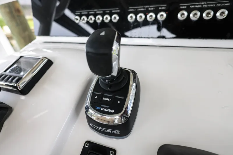 Slide: The Image of 2018 Sportsman Open 282 Center Console boat control panel with joystick and switches. - 11
