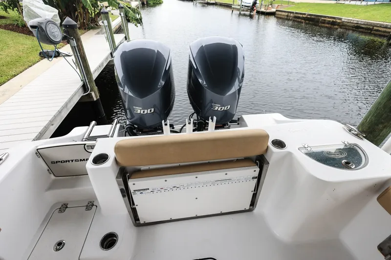 Slide: The Image of 2018 Sportsman Open 282 Center Console with twin 300 horsepower engines docked by water. - 5