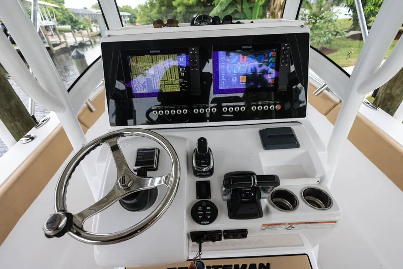 Slide: The Image of 2018 Sportsman Open 282 Center Console dashboard with dual Simrad displays and steering wheel. - 10