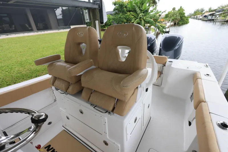 Slide: The Image of 2018 Sportsman Open 282 Center Console boat with tan seating and dual engines. - 8