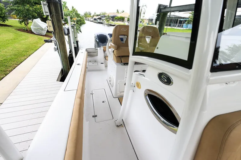 Slide: The Image of 2018 Sportsman Open 282 Center Console boat docked, featuring spacious seating and sleek design. - 19