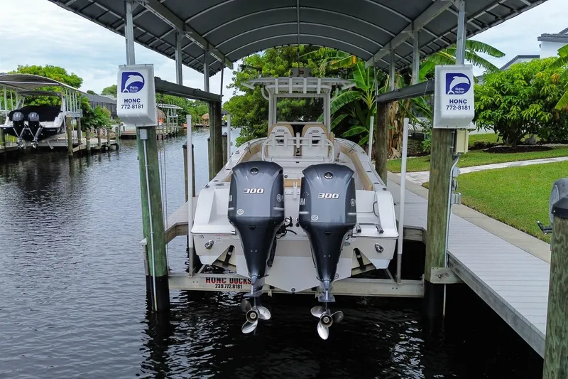 Slide: The Image of 2018 Sportsman Open 282 Center Console boat docked under a covered slip. - 3