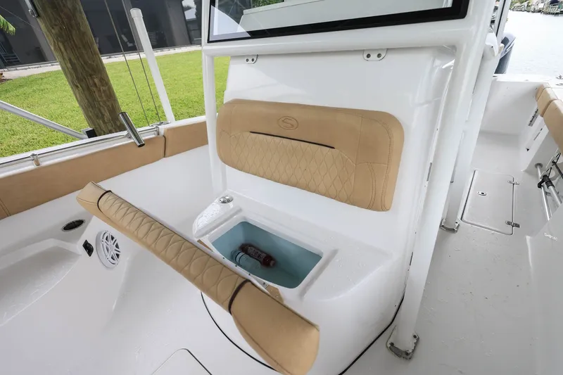 Slide: The Image of 2018 Sportsman Open 282 Center Console interior with cushioned seating and storage compartment. - 18