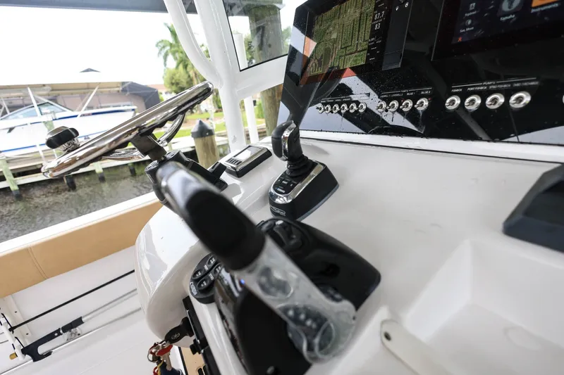 Slide: The Image of 2018 Sportsman Open 282 Center Console dashboard with steering wheel and navigation controls. - 21