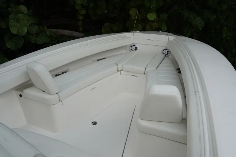 Slide: The Image of 2027 Regulator 25 boat interior with white cushioned seating and speakers. - 16