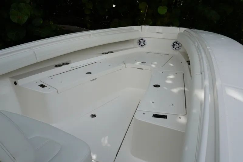 Slide: The Image of 2027 Regulator 25 boat interior with white seating and storage compartments. - 14