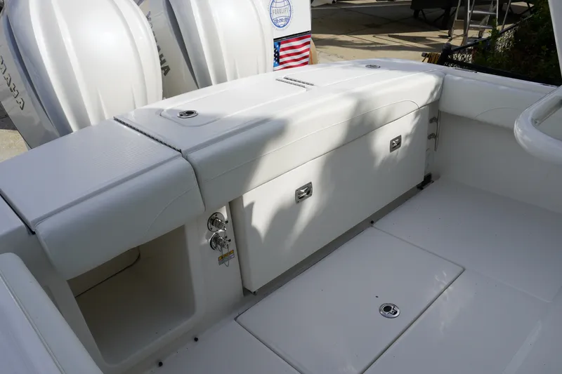 Slide: The Image of 2027 Regulator 25 boat interior with storage compartments and sleek white design. - 3