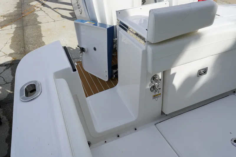 Slide: The Image of 2027 Regulator 25 boat interior with open storage compartment and seating area. - 4