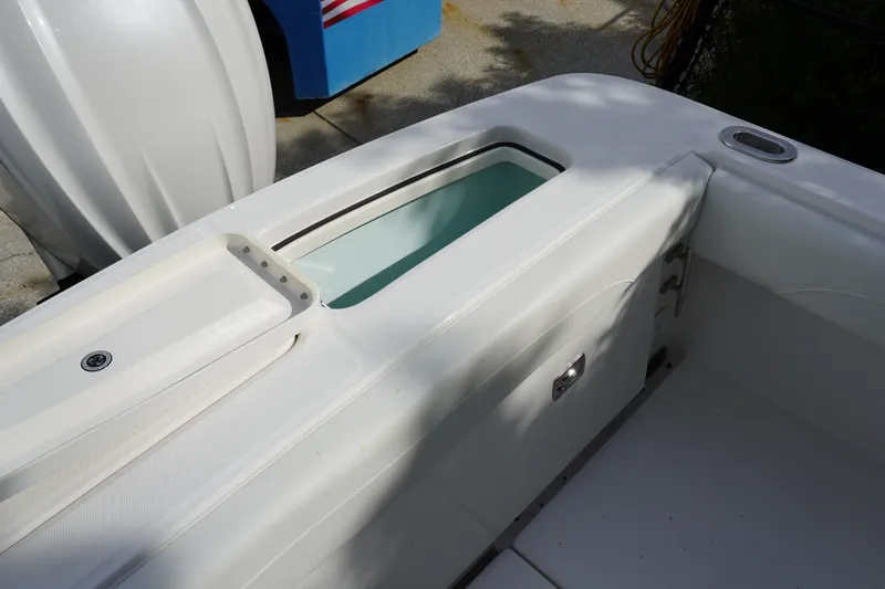 Slide: The Image of 2027 Regulator 25 boat interior detail with storage compartment and seating. - 6