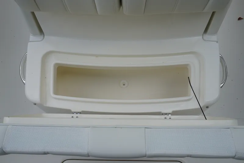 Slide: The Image of 2027 Regulator 25 boat storage compartment with open lid, showcasing interior space. - 18