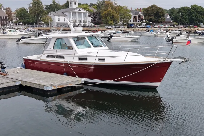 Slide: The Image of 2007 Sabre 34 Express boat docked in a scenic marina setting. - 1