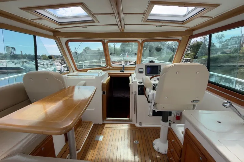 Slide: The Image of Interior of 2007 Sabre 34 Express yacht with helm, seating, and wooden flooring. - 4