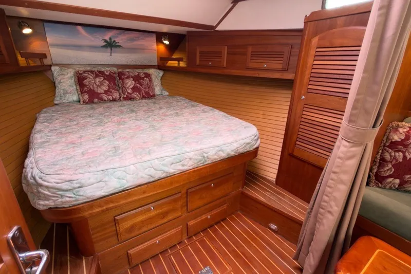 Slide: The Image of Luxurious cabin interior of 2007 Sabre 34 Express yacht with cozy bed and wooden finish. - 18