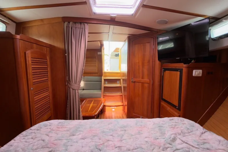 Slide: The Image of Interior of 2007 Sabre 34 Express yacht with wood finish, bed, and TV. - 21