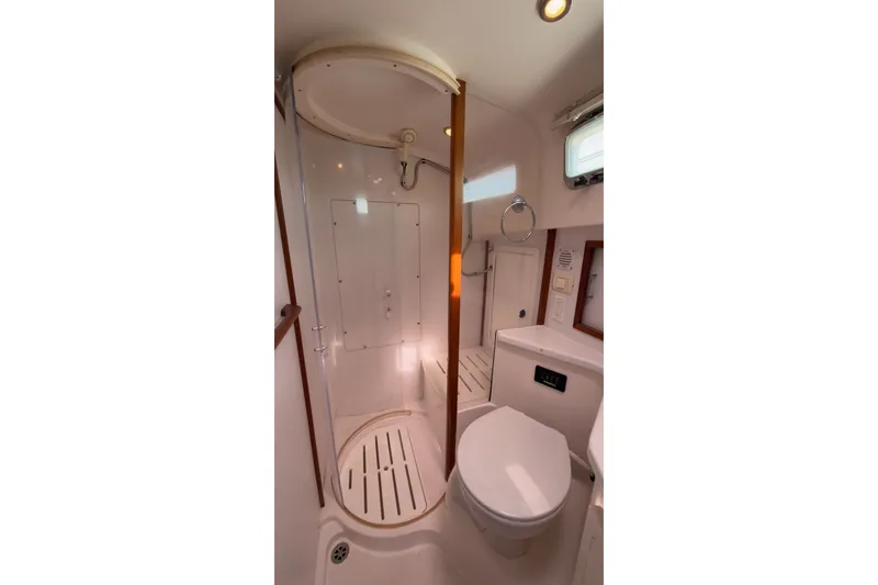 Slide: The Image of 2007 Sabre 34 Express yacht bathroom with shower, toilet, and wooden accents. - 22