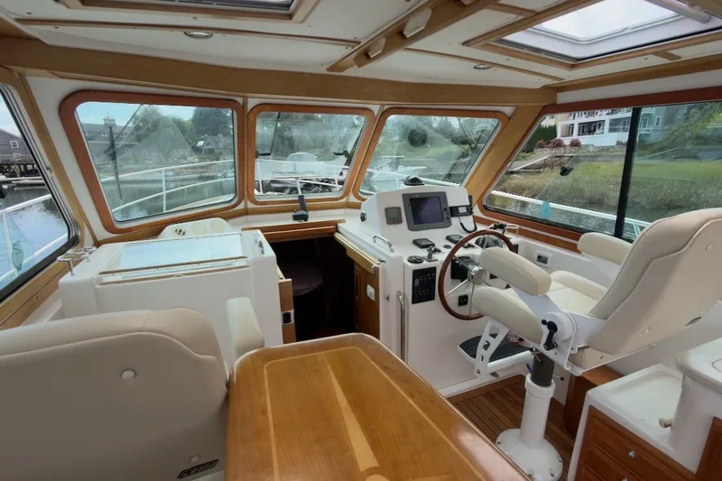 Slide: The Image of Interior of a 2007 Sabre 34 Express boat with helm and seating area. - 7