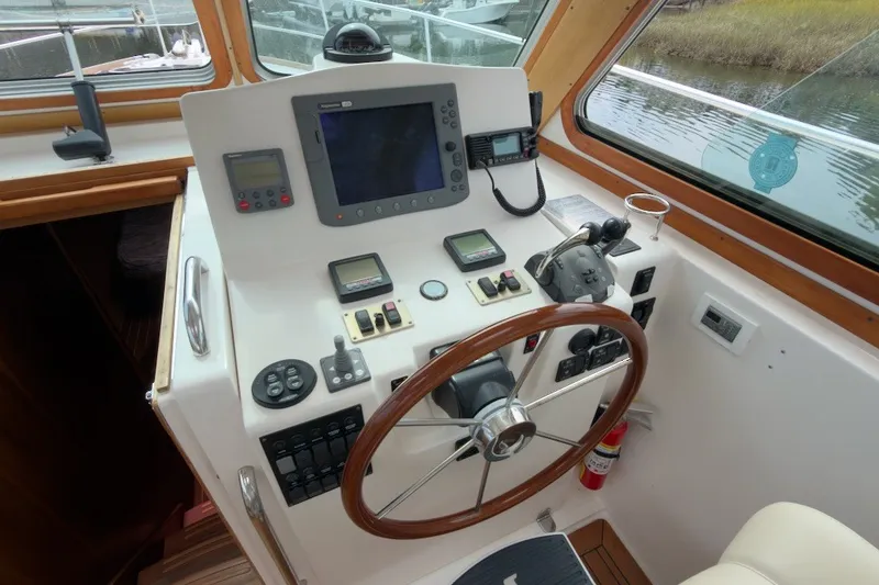 Slide: The Image of 2007 Sabre 34 Express helm with navigation equipment and wooden steering wheel. - 8