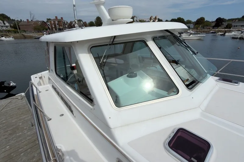 Slide: The Image of 2007 Sabre 34 Express yacht docked at a marina, showcasing its sleek design and windows. - 33