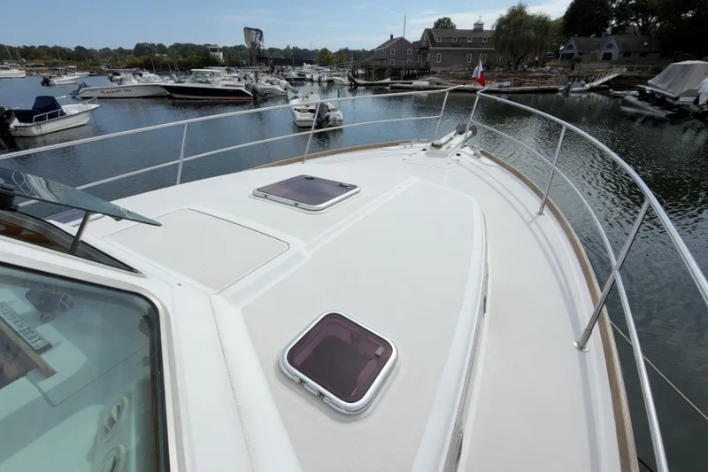 Slide: The Image of 2007 Sabre 34 Express yacht docked in a marina, showcasing its sleek deck design. - 32
