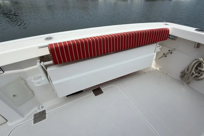 Slide: The Image of 2007 Sabre 34 Express boat interior with red-striped seating and rope storage. - 30