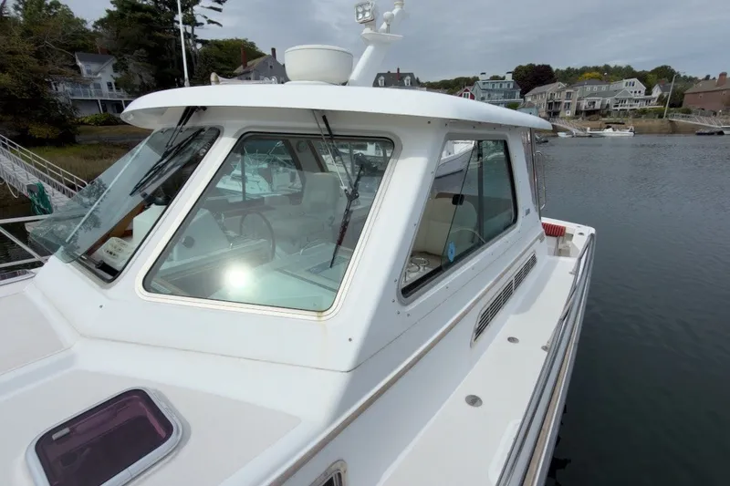 Slide: The Image of 2007 Sabre 34 Express boat docked near waterfront homes. - 34