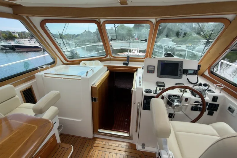 Slide: The Image of Interior view of 2007 Sabre 34 Express yacht cockpit with steering wheel and navigation equipment. - 5