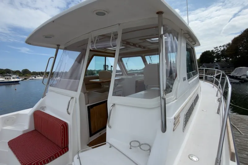 Slide: The Image of 2007 Sabre 34 Express yacht with enclosed cockpit, docked by the water. - 26