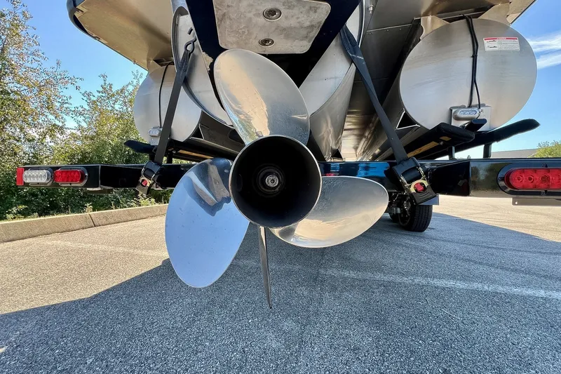 Slide: The Image of Rear view of 2025 Harris Solstice 230 boat propeller and trailer in parking lot. - 18