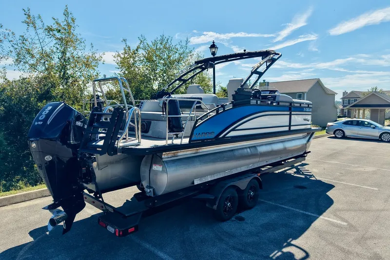 Slide: The Image of 2025 Harris Solstice 230 pontoon boat on trailer, parked in sunny lot. - 65