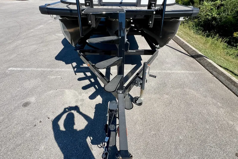 Slide: The Image of 2025 Harris Solstice 230 boat trailer parked on asphalt, shadow visible. - 59