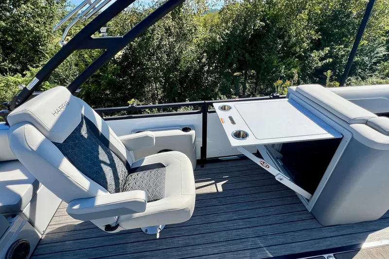 Slide: The Image of 2025 Harris Solstice 230 boat interior with luxury seating and foldable table. - 42