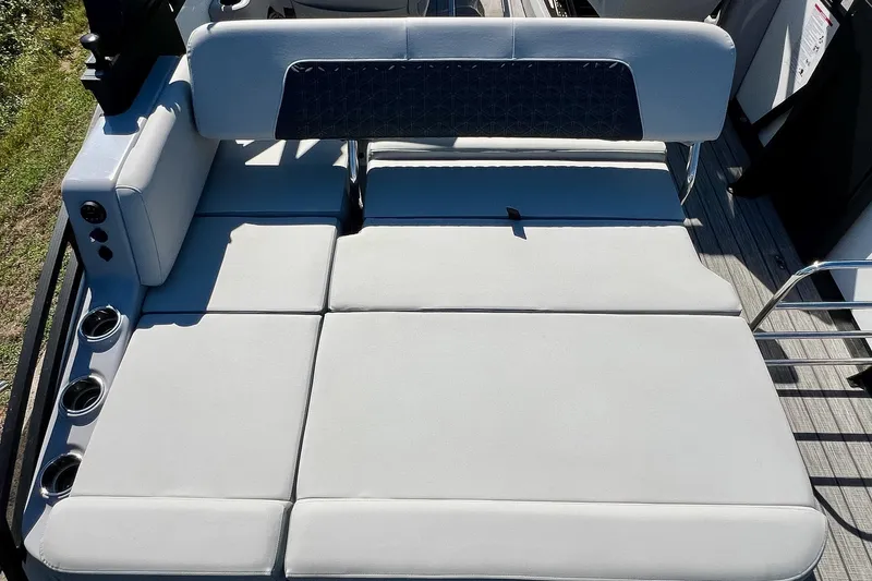 Slide: The Image of 2025 Harris Solstice 230 boat with spacious, cushioned seating and integrated cup holders. - 49