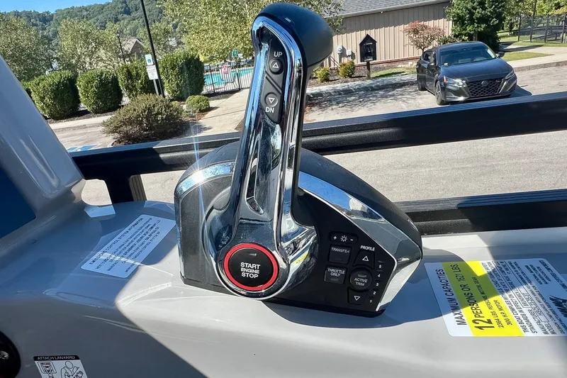 Slide: The Image of Throttle control of 2025 Harris Solstice 230 boat with start/stop button, outdoors. - 39