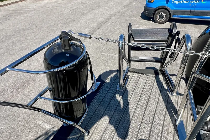 Slide: The Image of 2025 Harris Solstice 230 boat deck with stainless steel railing and black fender. - 55