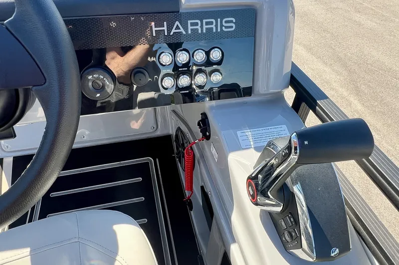 Slide: The Image of 2025 Harris Solstice 230 boat dashboard with steering wheel and control panel. - 38